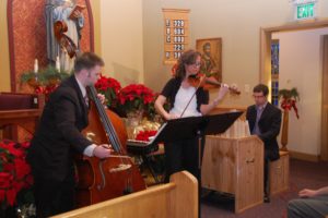 Matt Henry played the double bass, accompanied by Kristin Yoshimura on violin and Scott Powell on organ at the Jan. 2 Epiphany concert at St. Thomas Aquinas Catholic Church, in Camas. The violin was made by Alan Boehlke, who also constructed the pipe organ with Powell. It was Powell's senior project at Washougal High School last year. "I really wanted to do something that no one else at that school had ever done," he said. "Only a handful in that area had ever played before."