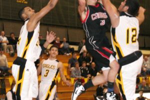 Bryan Butler takes on two Eagles Thursday night, at Hudson's Bay High School in Vancouver. The Camas boys lost this exciting contest, but bounced back by beating Prairie to move into first place in league.