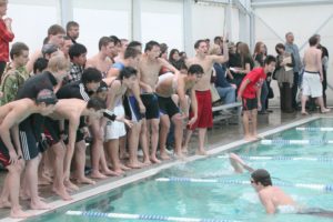 Swimmers from Camas and Mountain View high schools cheer on their teammates during a wet and wild meet for the league championship Thursday, in Camas.