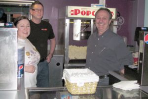 After being closed for more than a year, the Liberty Theatre in downtown Camas was open for the public to take a peek inside during First Friday events.  Although no movies were being shown, owner Rand Thornsley (center) and co-managers Jodi Vera (left) and Jim Burns (right) and assistant manager Fabiana Thomas (not pictured) were on hand to greet visitors.  The three-day grand opening event will begin Thursday, March 17. The celebration will include movies, live music, food and beverages.