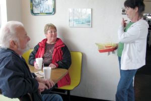 Marlene Macrae-Smith, co-owner of the Old Fashion Maid Restaurant, chats with customers in the dining area. She and her husband John (not pictured) have owned the Camas eatery for a total of 27 years. They plan to close the restaurant this month, retire and move back to Everett, to live near family members.