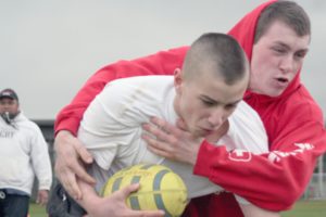 Tanner Lupton tackles Caleb Walz during Thursday's rugby practice in the field behind Liberty Middle School, in Camas. Lupton and Walz are two of the 15 Camas High School athletes on the Rugby Oregon "Mean Machine" team coached by Aisea Vailea.