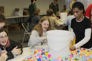 Students from the Washington State School for the Blind in Vancouver help to stuff plastic Easter eggs with candy and prizes on Wednesday at the Camas Community Center.  The 10,000 eggs will be hidden at Crown Park in Camas as part of the annual Camas Parks and Recreation egg hunt on Easter Sunday.