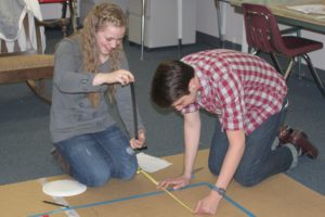 CHS Science Olympiad team members, including sophomore Katelynne Jones (left) and senior Ryan Gompertz (right) gathered Monday night to practice for the upcoming national tournament on May 20 and 21 in Wisconsin. Five days a week the team works out of its "clubhouse," one of the portables at Lacamas Heights Elementary School. Coach Ron Wright has called the facility one of the keys to the team's success.