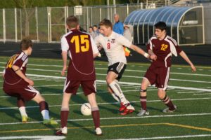 Drew White blasts through Prairie's line of defense to score two goals for Camas Friday, at Doc Harris Stadium. The Papermakers clipped the Falcons 6-1.