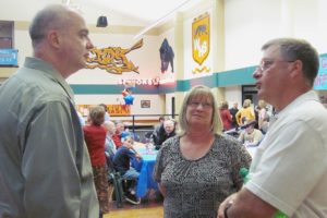 Tom Davis (left) talked with Washougal Police Department Administrative Assistant Pat King (center) and former Police Chief Bob Garwood (right), Saturday night at Washougal High School. A retirement dinner was held for Davis, who ended his 25-year career in law enforcement in December because of rheumatoid arthritis.