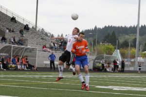 Parker Roland (left) heads up for the soccer ball Saturday, at Doc Harris Stadium. Camas beat Auburn Mountain View 1-0 to advance to state for the 13th straight season.