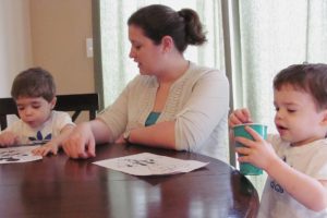 Shannon Young interacts with twin sons Connor (left) and Garret (right), 27 months, during coloring time. Young, a former volleyball coach at Washougal High School, is a member of Columbia Mothers of Twins Club. "The group has given me a chance to meet and become friends with a group of women who have been in my shoes," she said. "I have one of the youngest sets of twins in the group, and the twins moms are a constant for support and advice."