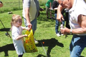 Catching a fish brings a smile to a kid's face during the 2011 Camas Moose Lodge fishing derby.