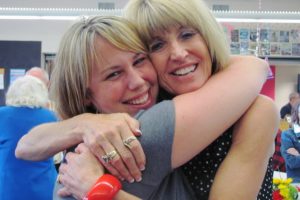 Gail Welsh, right, hugs a co-worker at her retirement party last week. "I've never really had a bad day in 42 years," she said. "Just when I lose hope, something happens."