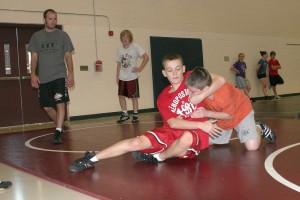 University of Northern Colorado wrestling coach, and former Evergreen High School wrestler, Ben Vom Baur (far left) directs kids on the the mat Friday, during the final day of the Clark County Coach-A-Roo wrestling camp, at Skyridge Middle School in Camas.