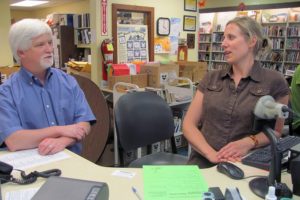 Washougal Community Librarian Sean McGill (left) talks with  Library Assistant Rachel Kuerzinger (right). For 13 years, McGill has planned events and performances by fiddlers, magicians and a "Creature Feature" snake wrangler, as well as a Lewis and Clark-era cooking demonstration and several doll and teddy bear tea parties. He has been reassigned to serve as the community librarian in Ridgefield, starting Sept. 1. Christine Hughey, community librarian in Stevenson and North Bonneville for six years, will relocate to Washougal.