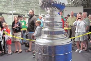 Hockey fans line up to touch the Stanley Cup Wednesday, at the Mountain View Ice Arena in Vancouver.