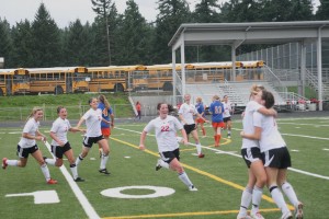 The Camas girls soccer team scored a big goal Saturday, to get back to state. Annike Sumpter (left) hugs Kaliee Esser (right), and Sara Slayton, Raya Klein, Ciara Klein, Janae Benson, Carley Marshall and Adrienne Engel (left to right) run up to join in the celebration.