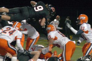 Addison Owen (9) goes over the top to score a huge touchdown for the Camas Papermaker football team in the state quarterfinals with the Lakes Lancers at Doc Harris Stadium in November 2010. A new study says football is the most dangerous sport for youth athletes.