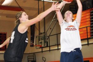 Chandler Audette (left) reaches out to defend a shot by Maddie Down (right) during a Washougal High School girls basketball practice.