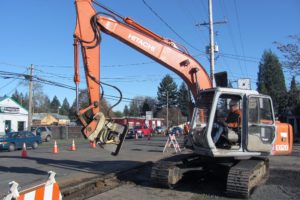 A track hoe compacts rock after the replacement of a gas line at the 2100 block of "E" Street, in Washougal. Drivers have had to slow down or stop as single lane closures went into effect on the roadway. An $8.1 million project will include conversion of the road width to two through-lanes and a center left turn lane, as well as bike lanes and sidewalks from Sixth to 32nd streets. It is expected to be completed in August 2011.