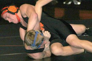 Michael Huck drives his opponent's shoulders into the mat to win by pin fall for Washougal. John Barrette and Robert Melton also pinned their opponents, but it would not be enough to catch a determined Camas squad.