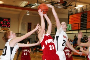 Washougal Panthers' Sara Brown (left) and Maddie Down (right) make life miserable for a Fort Vancouver Trapper. Six arms plus two determined teams going after one basketball equals a fun game to watch.