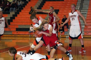 Sydney Allen and a Tiger scratch and claw for the basketball Dec. 21, in the Battle Ground Tournament.