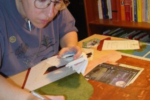 Contributed photo
Artist Sue Clancy works on a commissioned portrait of New York Times best-selling author Billie Letts. Here, she focuses on ink and acrylic detailing, after the cut paper pieces have been glued on and have dried.