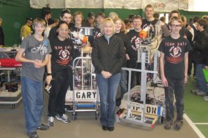 Members of the Camas-Washougal Robotics Team pose for a picture with Mary Tipton after a competition at Catlin Gabel school in Portland. The team named the robots in Gary Tipton's honor after the family made a donation to the team from his memorial fund. Mary was Gary's wife and is a Camas School Board member.