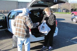 Kevin Shaw, a donation attendant for Goodwill Industries, accepts contributed items, in the Evergreen Marketplace, in Washougal. It is one of several places that accepts usable clothing, toys and household goods.