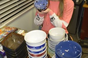 McKenzie Kitchen holds one of the many bowls that will be given to those attending a soup dinner fund raiser at Excelsior High School.