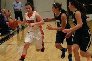 Alyssa Blankenship dribbles the basketball by two Hockinson Hawks Friday, at Washougal High School. The Panther scored 16 points to help Washougal win 48-45.