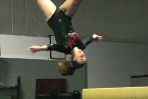 Jacquelyn Purwins flips off the beam during the Winterfest Invitational Saturday, at Naydenov. The Camas High School freshman won the event with a score of 9.05.