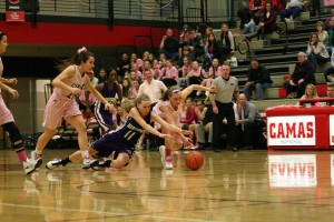 Meghan Finley (right) lunges for the basketball Friday, at Camas High School. The Papermakers beat the Heritage Timberwolves 62-20. See more photos from the Hoops for Pink game at www.camaspostrecord.com.