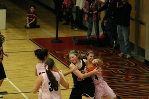 Camas Papermakers Kimi Knight, Brenna Khaw and Nikki Corbett surround a Battle Ground Tiger during the Hoops for Pink game Friday night, in the Camas warehouse. The Papermakers handled the Tigers 55-26.