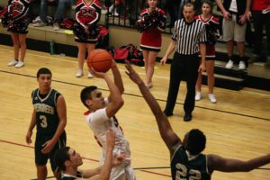 Andre De Los Rios rises above Robert Franks and scores a basket for the Papermakers. The Camas boys defeated Evergreen 62-49 Friday, at Camas High School.