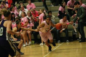 Rachel Gray dribbles the basketball on Hoops for Pink night Thursday, at Camas High School. The Papermaker girls defeated Heritage 49-23 for their 14th victory in a row. The Camas boys also defeated Heritage 59-41.