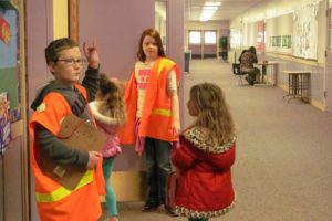 Fifth-graders Jaden Carstens (left) and Taylor Vincent are members of the Hathaway Elementary School Peacemakers program, designed to help decrease playground conflicts among younger students and promote positive behavior.