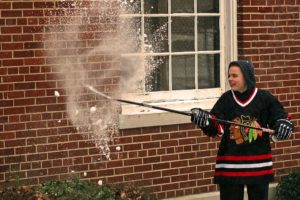 Ryan Stevens smashes a snowball with his hockey stick. The 14-year-old from Washougal plays for the Junior Winter Hawks. His family is one of 11 finalists hoping to become Toyota's Winter Hawks Family of the Year.