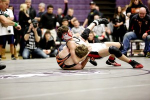 Camas' Austin Miller turns the tables on Battle Ground's Sean Trenda during the 132-pound 4A regional championship match Saturday, at Heritage High School. Miller won the match 13-11.