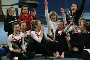 The Camas High School gymnasts celebrate with their coaches after being announced as the district champions Wednesday, at Northpointe in Vancouver. See the photo gallery at www.camaspostrecord.com.