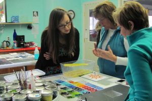 Studio13 GlassArt owner Shirley Bishop (center) explains safety precautions to Ruth Bosckis (left) and Anne Marie Standley before a recent class.