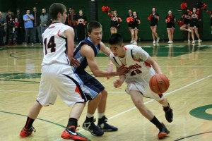 Sean Guthrie sets a screen for Austin Tran during the consolation finals of the district tournament Feb. 19, at Evergreen High School. Hockinson defeated Washougal in overtime 67-53.