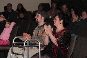 Belle Mathieu (right) applauds the performance of friend and singer Hayley Redinger Sunday night during a benefit auction and concert at Journey Community Church in Camas. The event was a fundraiser for Mathieu, co-owner of A Twist On Time, who is recovering after suffering a severe stroke in December. According to event co-organizer Peter Arvidson, $5,500 was raised.