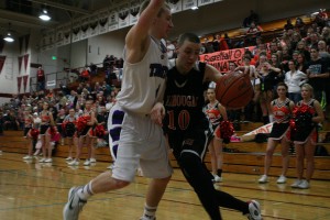 Washougal's David Crowley fights a North Thurston Ram for a lane to the hoop Feb. 21. The Rams held off the Panthers 62-56, but Washougal still brought home a fourth-place trophy.