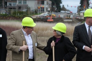 As excavating equipment hums in the background, government and business officials gathered for the ground breaking of the Northwest 38th Avenue/Southeast 20th Street extension project on March 5. Camas Mayor Scott Higgins (left) speaks with Shari Hildreth, deputy district director for U.S. Rep. Jaime Herrera Beutler, R-Camas.