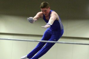 VEGA's Trace Jacquot, of Hockinson, flings himself over the high bar and catches it on the other side during the Level 10 USAG Washington state men's gymnastics meet Saturday, at the Clark County Event Center. He took third all-around.