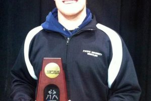 Camas wrestler Caleb Malychewski holds his fifth-place trophy from the NCAA Division III championship tournament.