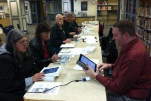 Washougal School Board members receive instruction on their new iPad2 devices from technology director Lester Brown, right. It is anticipated that the board will transition to completely paperless meetings within the next two months.