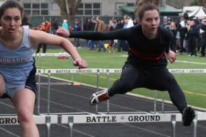 Washougal High School senior Kari Johnson (right) and a Mark Morris Monarch go toe-to-toe in the 100-meter hurdles at the Tiger Invitational Saturday, at Battle Ground High School. This track and field meet featured 19 schools from Clark County, Kelso, Longview and Chehalis.