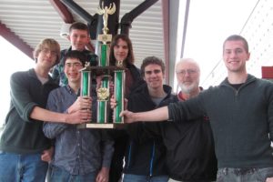 The 2012 CHS Knowledge Bowl team celebrates its "three-peat" last week. Team members include (front row) Evan Roche, Marcus Bintz, Griffin King, coach Dale Croswell and Noah Wachlin and (back row) Vaughn Okerlund and Tim Grote.