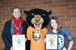 Taylor Grasseth (right), an eighth-grader from Jemtegaard Middle School, poses with her art teacher, Gabrielle Iverson, and the WSF Stride Cat. Grasseth won this year's Student Stride for Education logo contest.