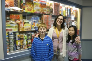 Julie Bristol, Gause Elementary social worker, had her birthday wish granted when students brought in 2,400 items for the Weekend Backpack Program. Here, she is pictured with student food contributors Jackson Rauch and Milan Shirakawa.